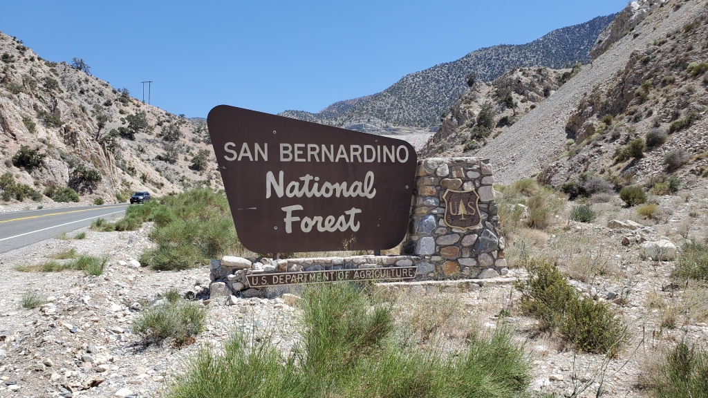 san bernardino national forest official brown sign with desert in background